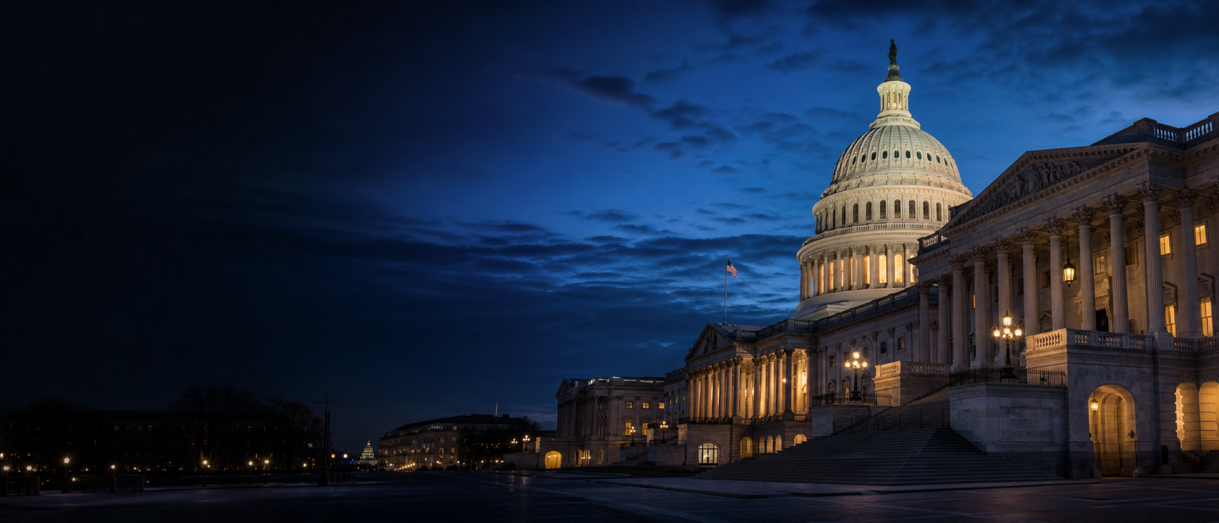The United States Capitol illuminated at dusk under a deep blue sky
